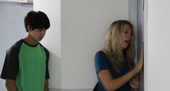 Debbie (Daisy Haggard) and Josh (Luca Oriel) at the doors of Nikki's apartment.